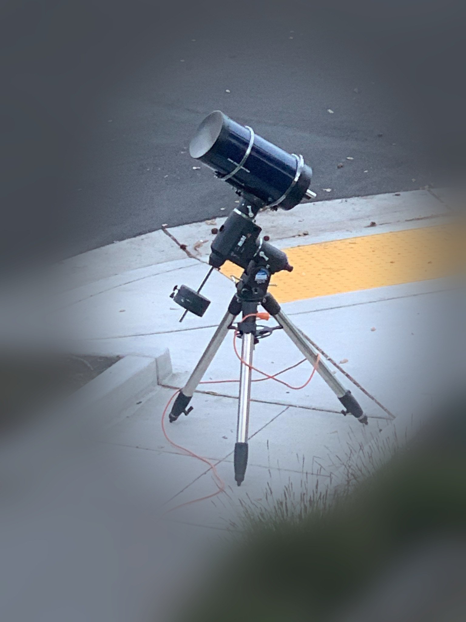 A 7 inch Maksutov telescope on an equatorial mount, outdoors at night