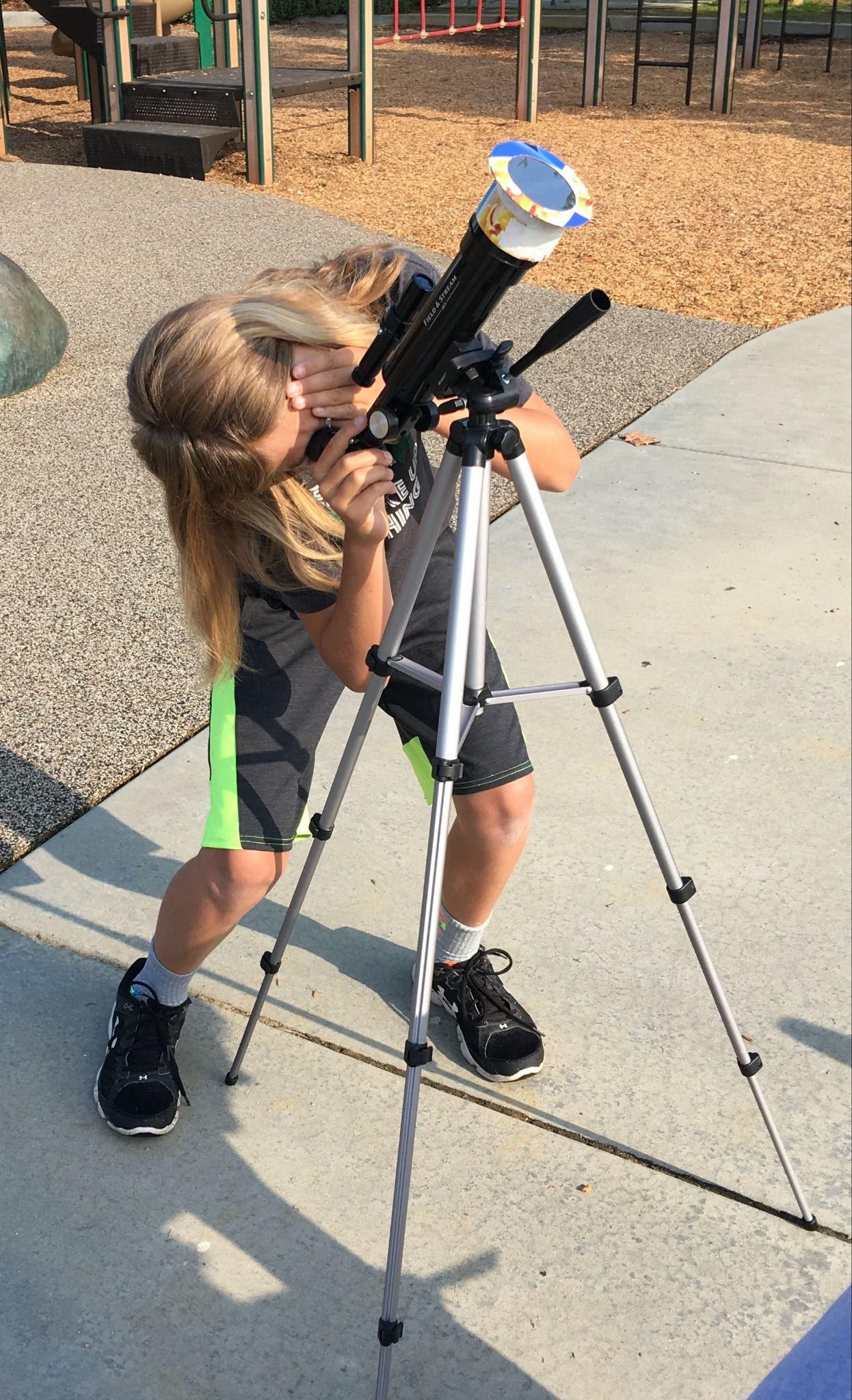 Adam at eleven, looking through a small telescope fitted with a home-made solar filter